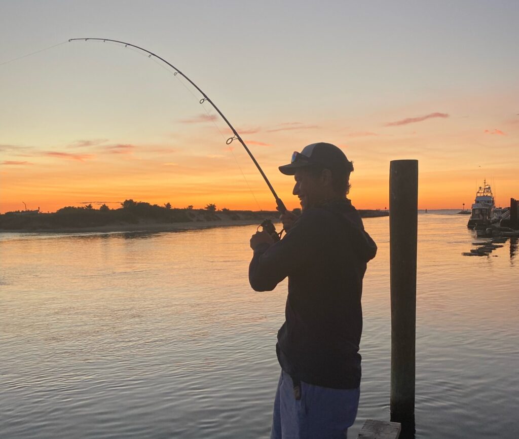 John fishing with sunset in background.